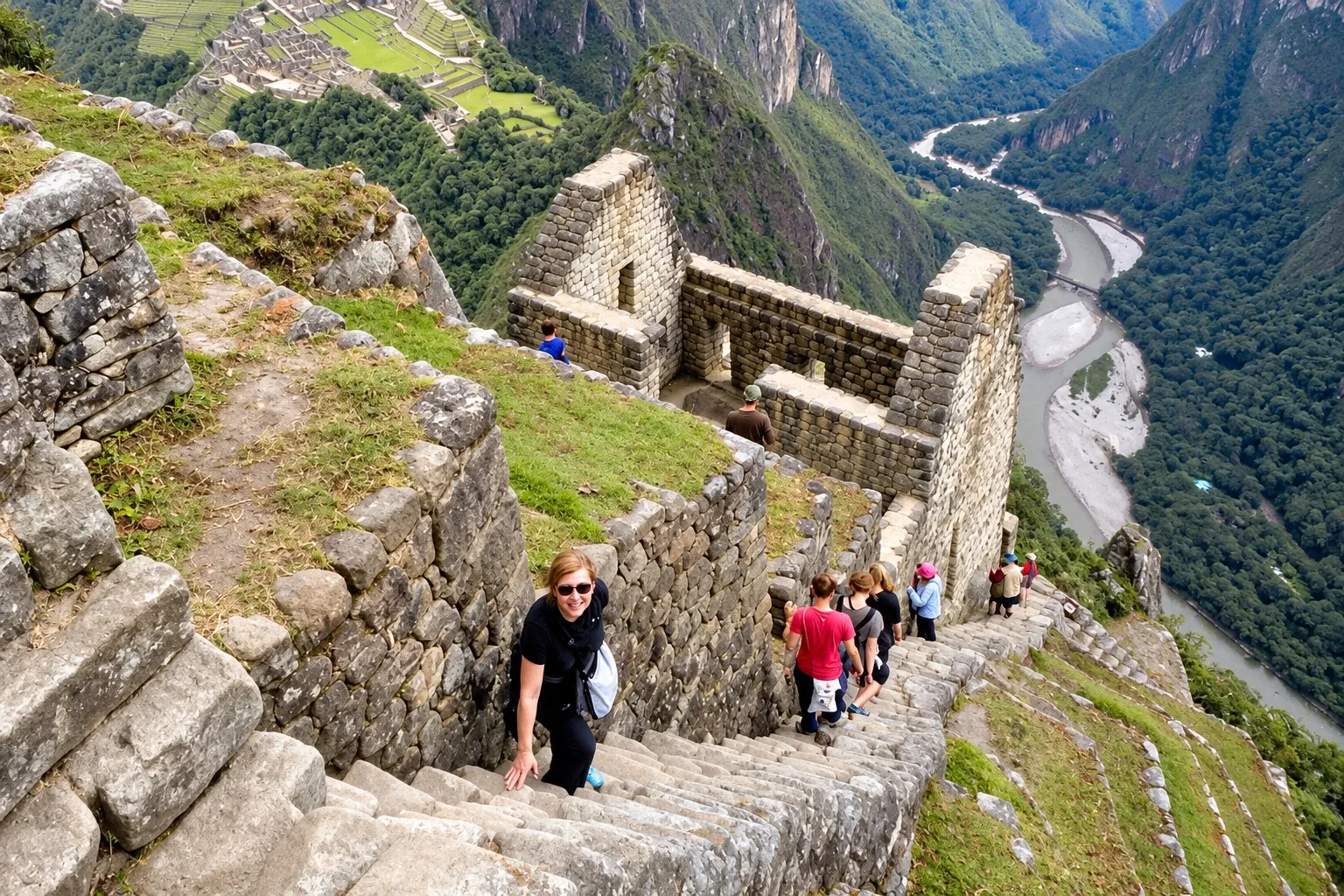 Walkers climbing a steep Inca staircase above the Urubamba river